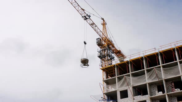 A Crane is Working on the Construction of a Multistorey Building in a New Neighborhood