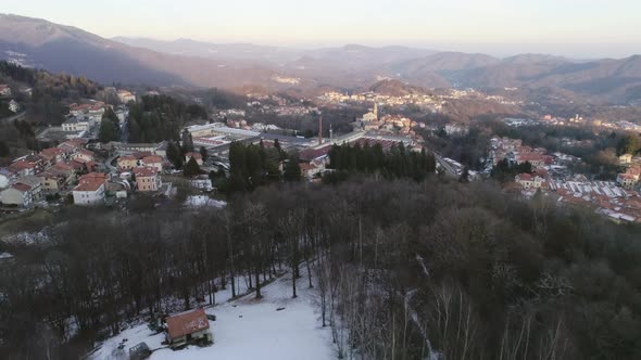 Overhead Aerial Drone Flight Over Snowy Forest Woods with People Walking alt