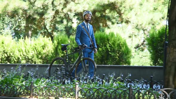 Hipster Businessman Walking With Bicycle To Workplace