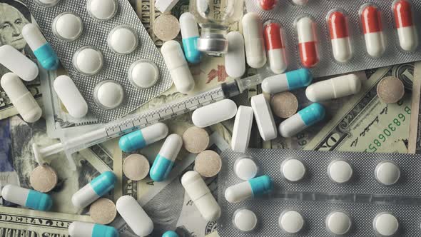 Close Up View of Medical Pills Rotating on the Dollar Banknotes alt