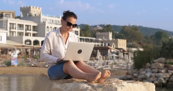 Woman Typing Sitting By Hotel alt