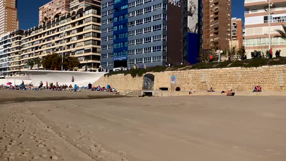 The beautiful south beach at Benidorm showing people doing exercises on beach