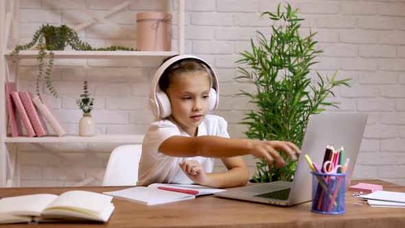 Little Child Girl Using Laptop Computer for Studying Online E-learning System