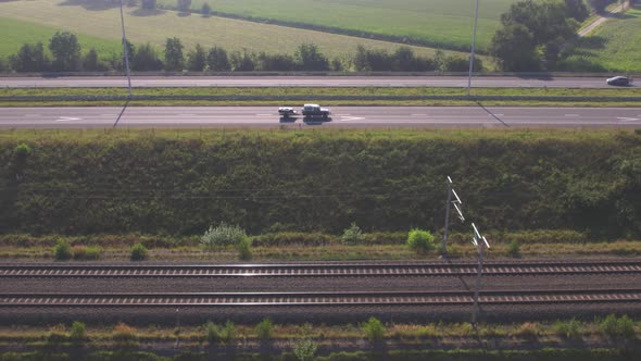 Overhead View of Cars Driving on a Highway Next to a Railroad During Summer in Belgium Europe alt