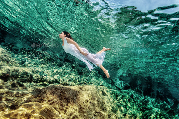 Woman swimming near rock - Stock Photo - Images