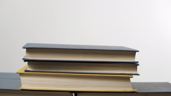 stack of various hardback books alt