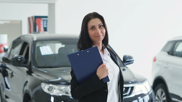 Young Beautiful Female Car Salesperson Manager At Car Shop