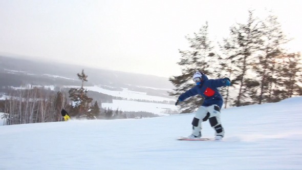 Snowboarder Riding Down the Hill alt