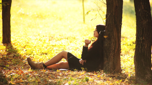 Girl Dreams Under Tree In Autumn Park