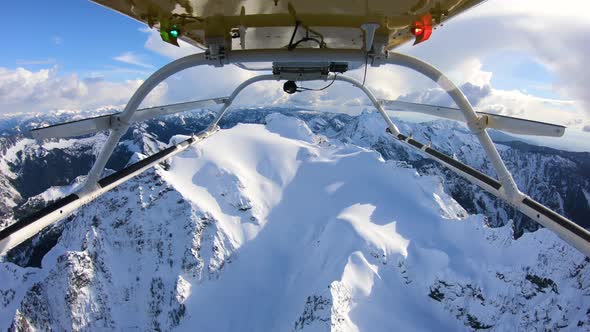 Winter Expedition Deep Into Mountainous Backcountry Flying Helicopter Reverse Skids View alt