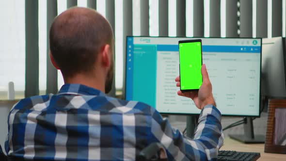 Businessman in Wheelchair Using Smartphone with Green Screen alt