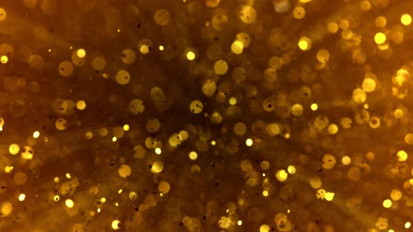 Super Slow Motion Shot of Golden Glitter Background at 1000Fps alt