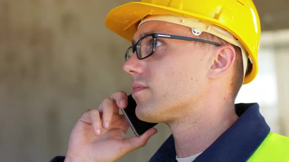 Male Builder Calling on Smartphone at Office
