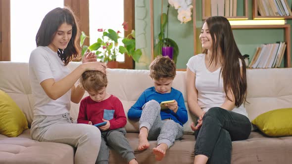 On the Sofa Two Ladies Young Mothers with Their alt