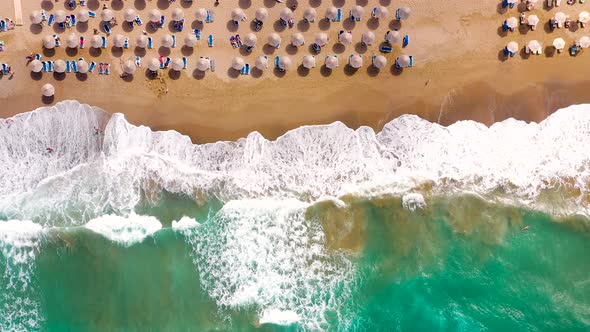 Aerial View of the Sea Sandy Beach Sun Umbrellas and Sunbeds Unrecognizable People alt