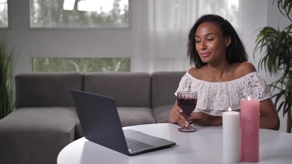 Happy Female Enjoying Distant Dating at Laptop alt