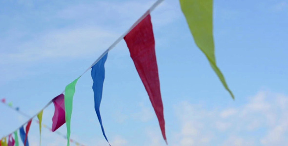 Multicolored striped triangular flags on a rope