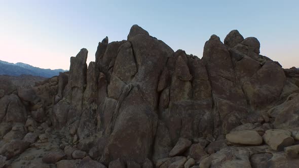Aerial shot of a young man backpacker camping with his dog in a mountainous desert alt