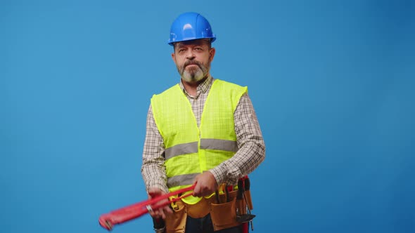 Senior Man Foreman Holding Tool Againast Blue Background