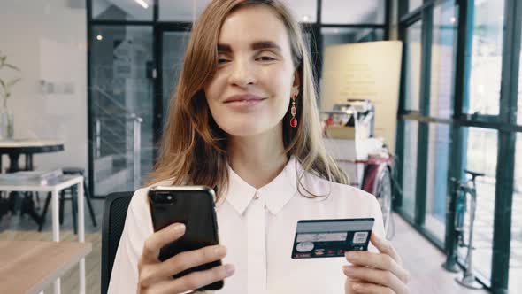 Businesswoman Online Shopping Using Credit Card And Smartphone