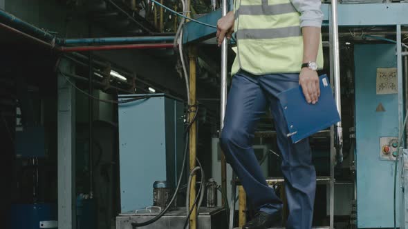 Engineer Getting Down from Platform at Factory alt
