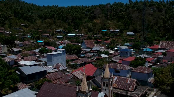 Aerial drone view of a small isolated village and situated at the bottom of a mountain close to the alt