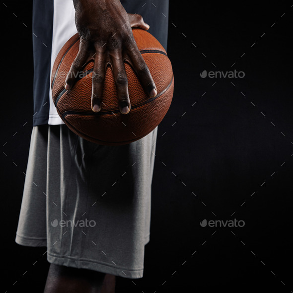 African basketball player holding ball - Stock Photo - Images