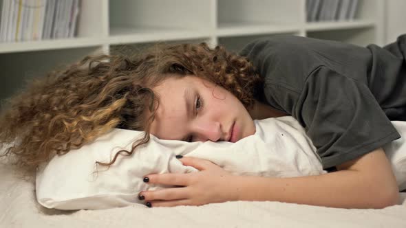 Distressed Introvert Teen 13s Girl Child Lies on Bed at Home Suffer From School Discrimination or