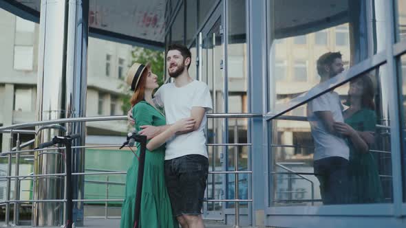 Happy Couple in Love Stands in Embraces and Has Talk in the City alt