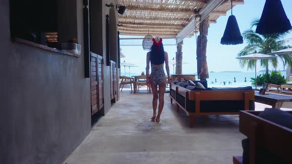 Back View Girl In Swimming Suit Walking Alone In Resort On Sunny Day Slow Motion alt