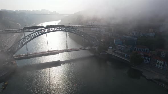 Porto Aerial Cityscape with Luis I Bridge and Douro River at Fog Portugal
