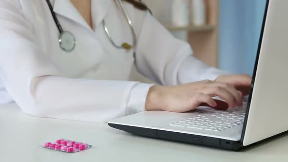 Female Physician Keeping Electronic Medical Records, Typing Online Prescription alt