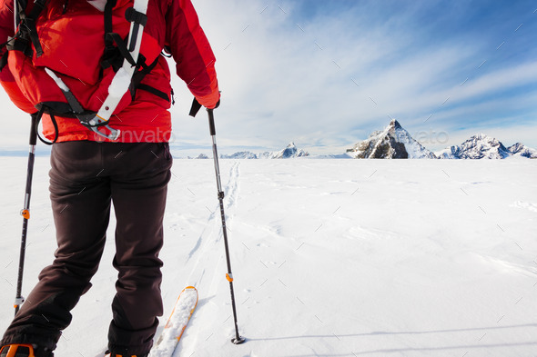 Mountaineer exploring a glacier with the skis - Stock Photo - Images