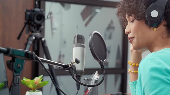 Attractive African American Young Woman Vlog and Podcast With Microphone alt