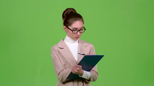 Manager Fills the Questionnaire with a Pen on a Paper Tablet. Green Screen alt