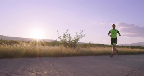 Triathlon  Male Triathlete Running in Triathlon Suit Training for Ironman Race
