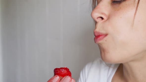 Young Sexy Woman Appetizing Eating Fresh Juicy Strawberry alt