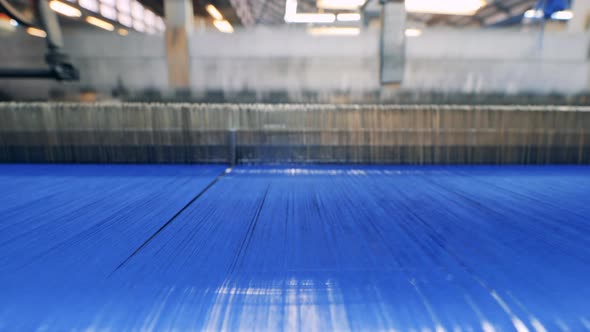 Factory Mechanism is Weaving with Blue Threads alt