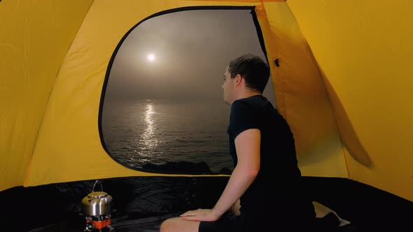 Young Hiker Opens Tent at Seashore and Looking at Idyllic Seascape, Spain