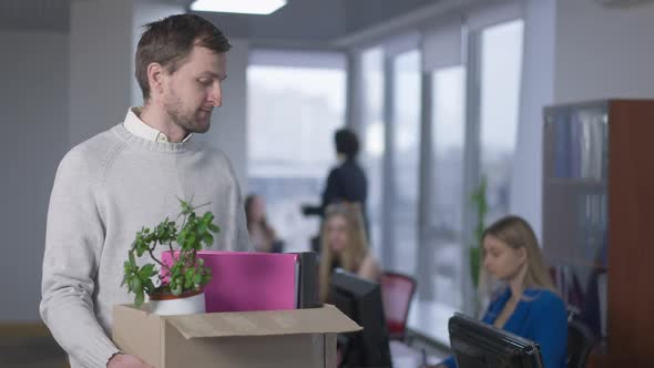 Portrait of Jobless Frustrated Caucasian Man Posing with Box in Office alt