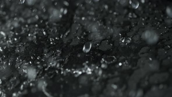 Super Slow Motion Shot of Water Droplets Splashing on Waterproof Cloth at 1000Fps alt