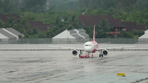 Airplane on the Airfield in the Rain alt