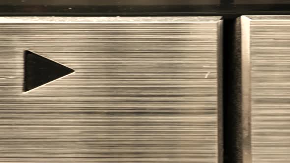 Extreme close up of buttons on an old antique or vintage VCR trucking across a play, stop, rewind an alt