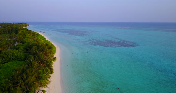 Wide birds eye clean view of a white sand paradise beach and blue sea background in high resolution  alt