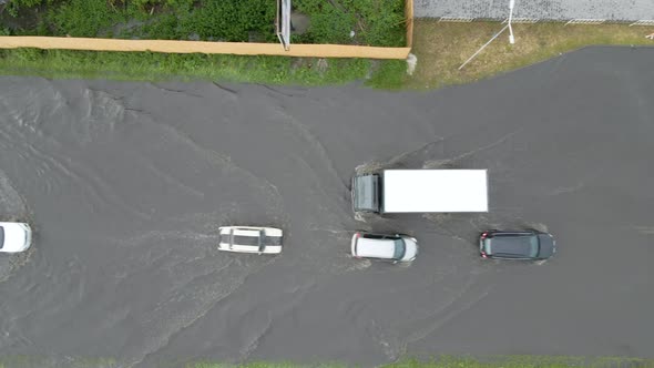 Aerial View of City Traffic with Cars Driving on Flooded Street After Heavy Rain alt