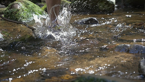 Slow Motion Runners Foot Splash in a Creek
