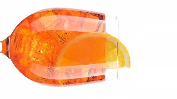 Aperol Spritz Cocktail with ice isolated on white background, rotation. alt