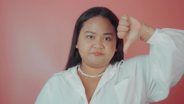 Portrait of an Asian Plus Size Woman with Thumbs Down alt