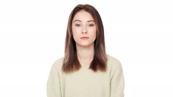 Portrait of Calm Young Woman with Long Brown Hair Looking at Camera Being Selfconfident and Isolated alt