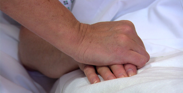 Holding Patients Hand in Hospital